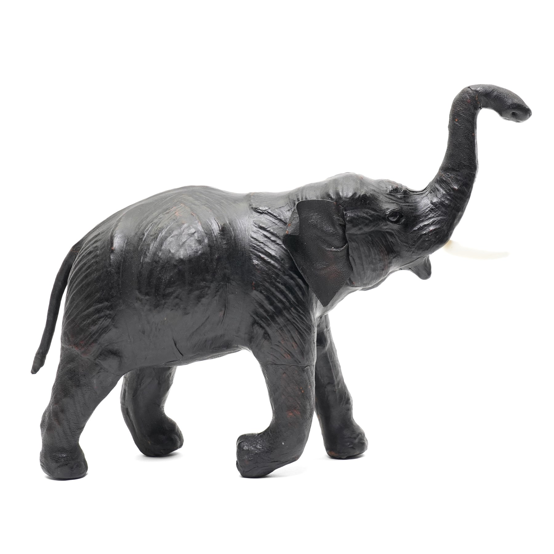 In the style of Liberty & Co - pair of 20th century ebonised papier mache elephants 