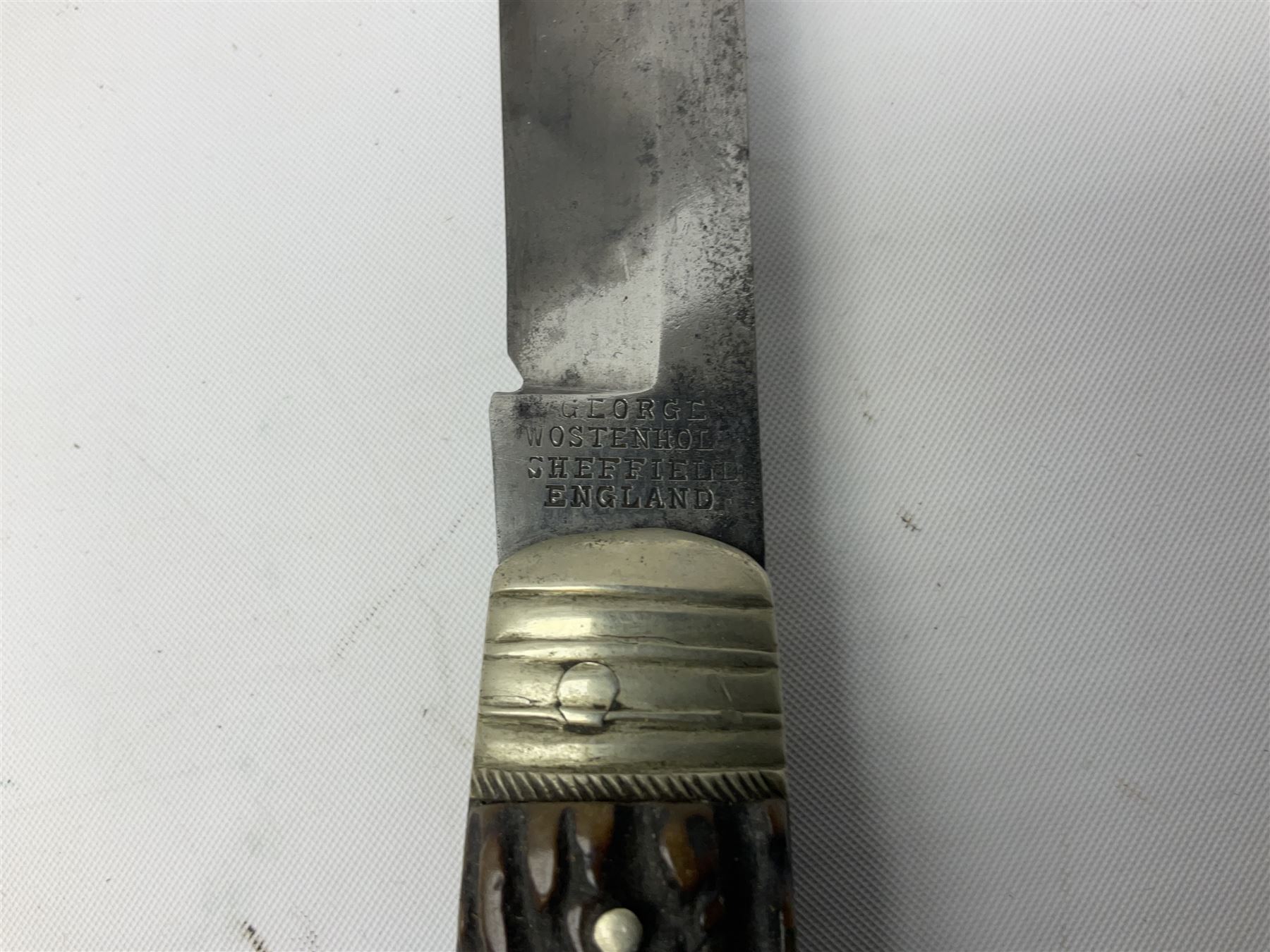 Hunting knife by J Nowill & Sons, Sheffield, the handle inset with mother of pearl, blade length 19cm; George Wolstenholme IXL lock-knife with antler scales L29cm open; and another Bowie style hunting knife marked 'V.R. Warranted Sheffield Joseph Ellis & Sons' in leather sheath (3)