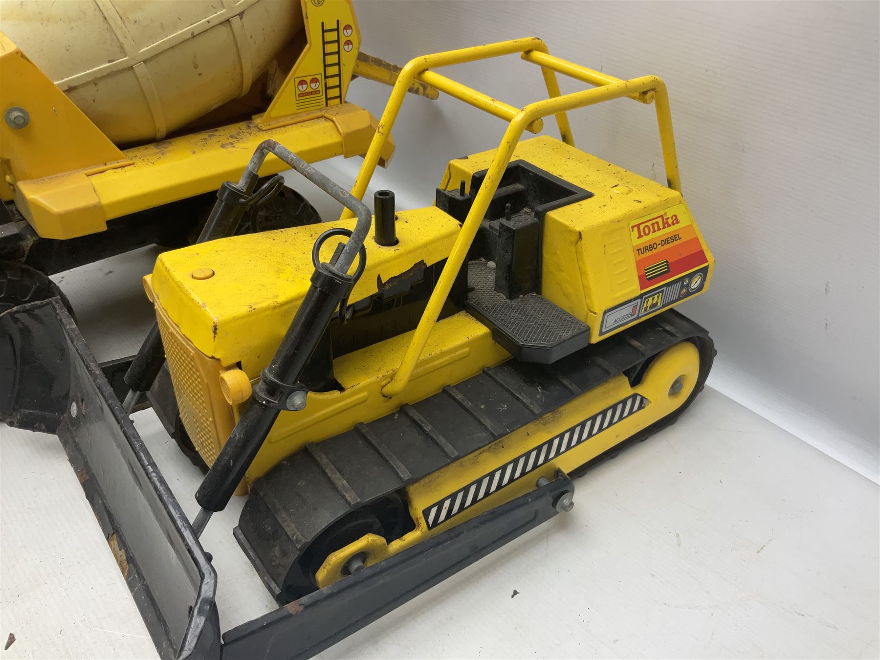 Tonka - five large scale pressed steel vehicles comprising Cement Mixer, Mobile Crane, Bulldozer and two Dumper Trucks (5)