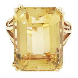 9ct gold citrine ring, single emerald cut citrine of approx 22.30 carat, set between openw...