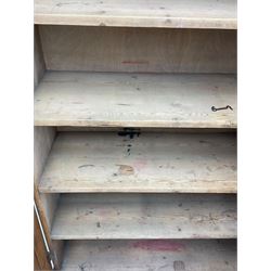 The North of England School Furnishing Company Limited Darlington - early 20th century oak school cupboard, projecting moulded cornice over two panelled doors, fitted with shelves, on chamfered plinth base 