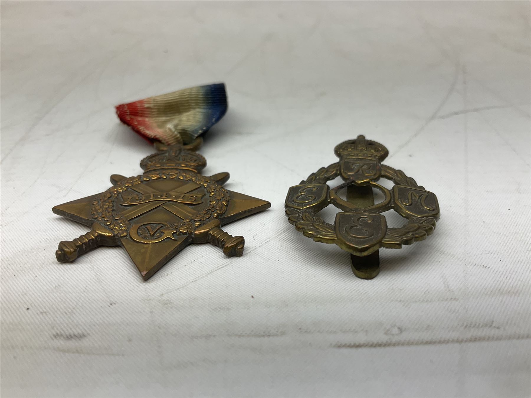 Three WW1 medals comprising 1914-15 Star awarded to 58648 Spr. C. Roberts R.E.; British War Medal and Victory Medal awarded to 87502 1.A.M. C. Roberts R.F.C.; and REME cap badge (4)