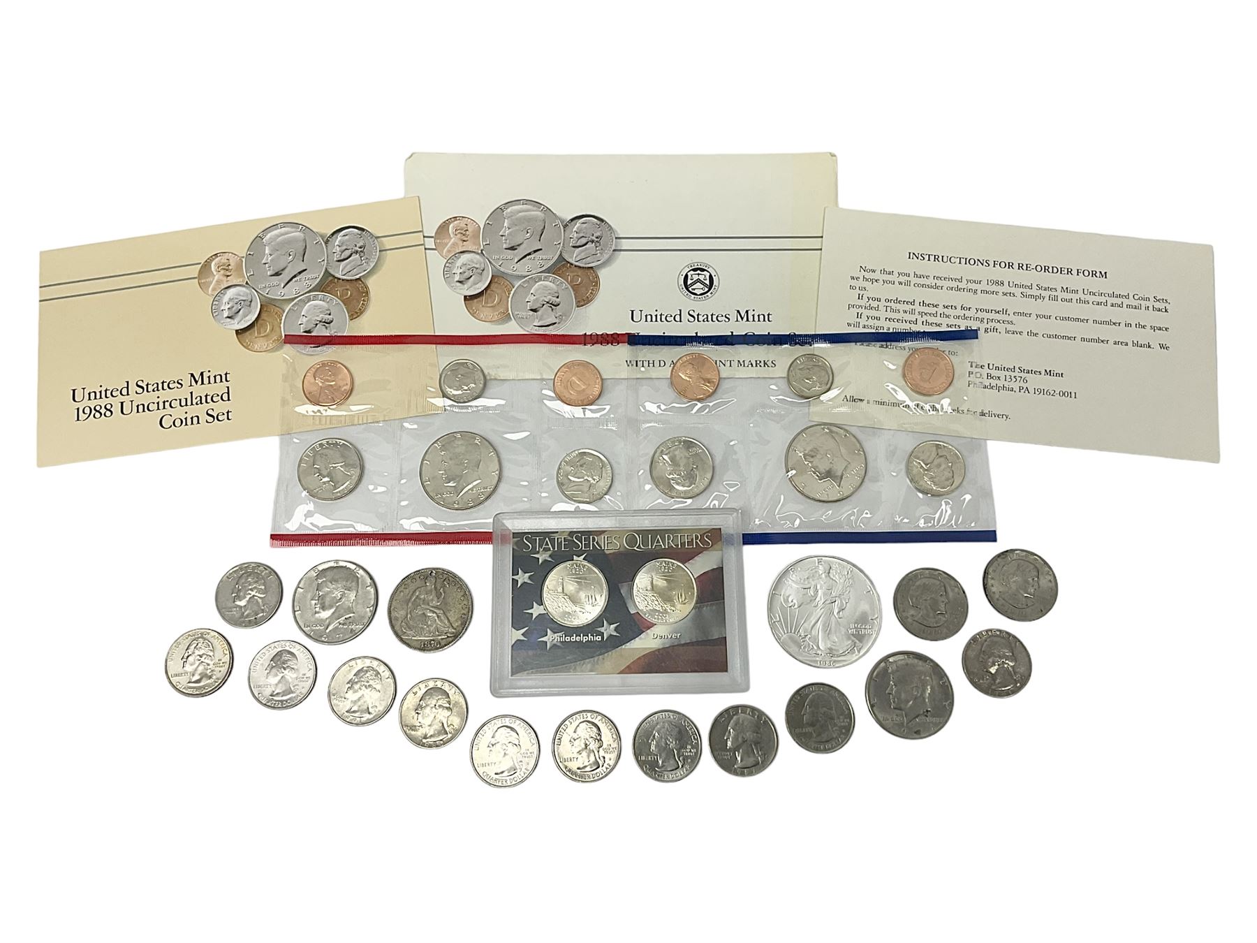 United States of America coinage, including 1876S half dollar (holed), various quarter dollars, 1986 one ounce fine silver dollar, 1988 uncirculated coin set etc