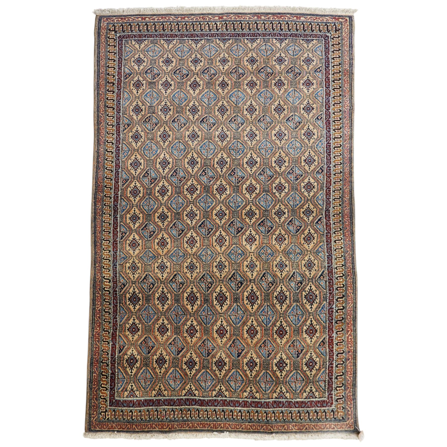 North East Persian Moud hand-knotted carpet, ivory field with an-over Herati inspired lattice of repeating lozenge and diamond motifs, with stylized floral devices and angular vinery in tones of sky blue, indigo, madder red and camel, principal border with a sequence of stylized palmettes and angular vine motifs, framed by narrow guard stripes, with cotton fringe ends