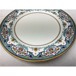 Four Minton plates, comprising three tea plates and one serving plate, hand painted with floral and scroll border and gilt edging, with printed mark beneath and retailer's mark for W.H Plimmer & co, New York City, largest plate D31.5cm