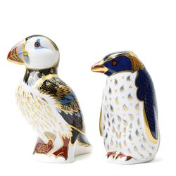 Three Royal Crown Derby paperweights, comprising Puffin with gold stopper, Rockhopper penguin with gold stopper, and Penguin and Chick with gold stopper, two with boxes (3)