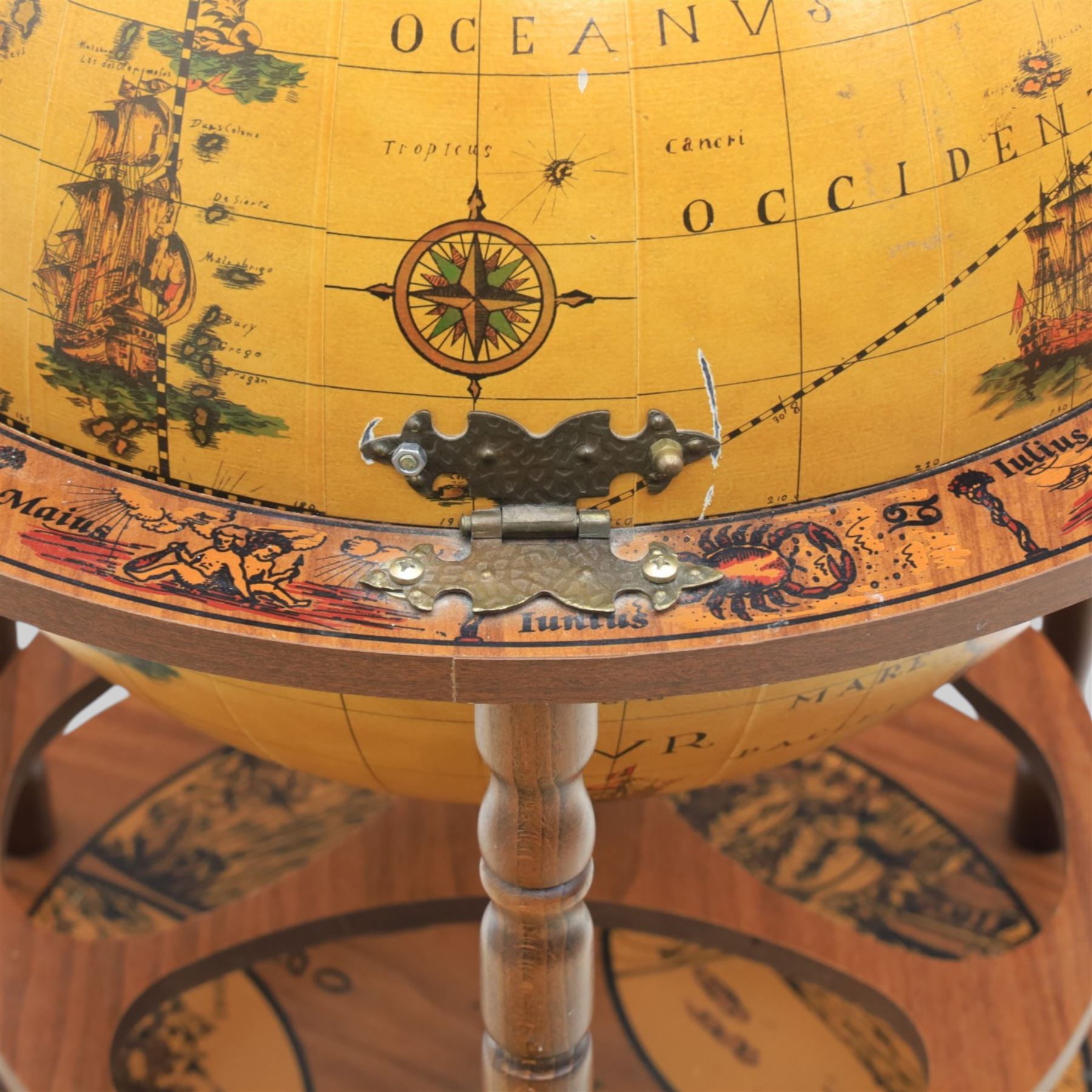 Late 20th century drinks globe, with lift off top with rotating inside with apertures for bottles, raised on brass castors