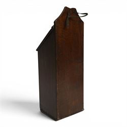 Three George III and later oak candle boxes, the first example of tapering form with shaped and pierced scroll crest, above a hinged lid, H50.5cm W18cm D13cm, the second of plain rectangular form with tapering crest, above a studded leather hinged sloped lid, H46cm W15.5cm D15.5cm, and third of plain rectangular form with demi-lune crest, with lift up front, H42.5cm W17.5cm D12cm 
