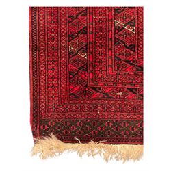 Turkoman red ground wool rug, the field with a repeating pattern of Tekke gul motifs in dark brown and red (195cm x 98cm); Afghan Bokhara red ground wool rug, central field with repeated geometric octagonal gul motifs, surrounded by multiple borders with stylised diamond and triangular patterns (127cm x 181cm)