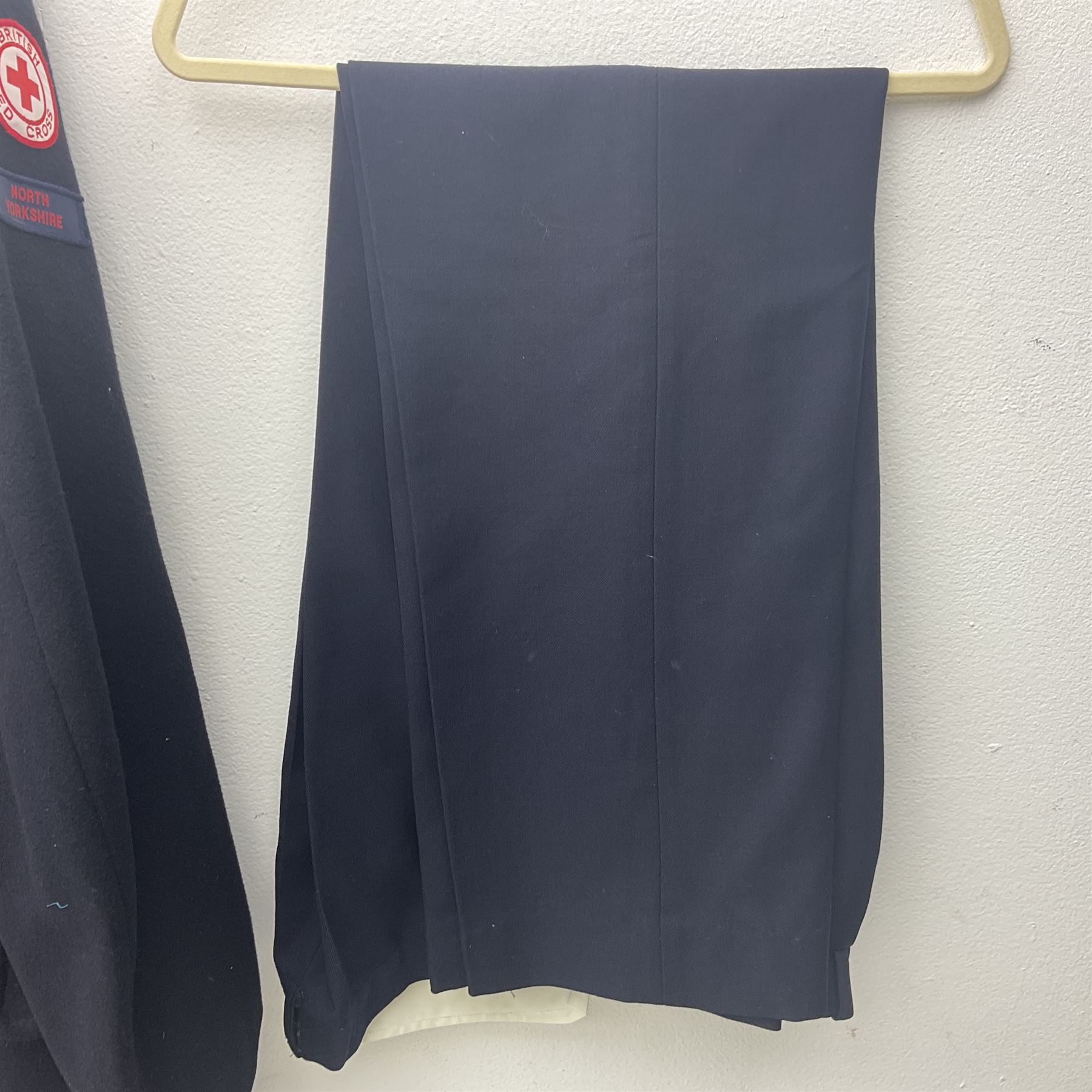 1950s British Red Cross North Yorkshire dress uniform comprising tunic, trousers, greatcoat and visor cap; bears manuscript label '1956 Ware'