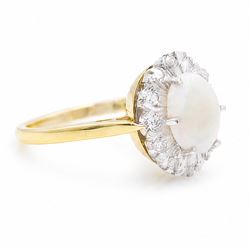 18ct gold opal and diamond cluster ring, oval cabochon cut opal surrounded by twelve single cut diamonds, London 1988