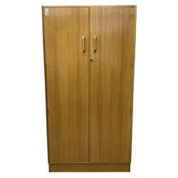 E. Gomme for G-Plan - 'Brandon' light oak double wardrobe, the interior fitted with hanging rail and shelves 