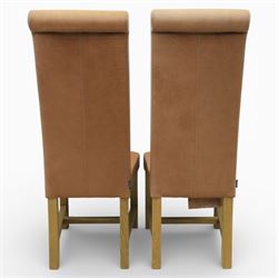 Modern large oak plank top dining table and twelve brown leather high back chairs, table of rustic construction five solid planks with exposed supports, the chairs in brown leather hide with ten standard height and a pair of taller chairs for the foot and head of the table