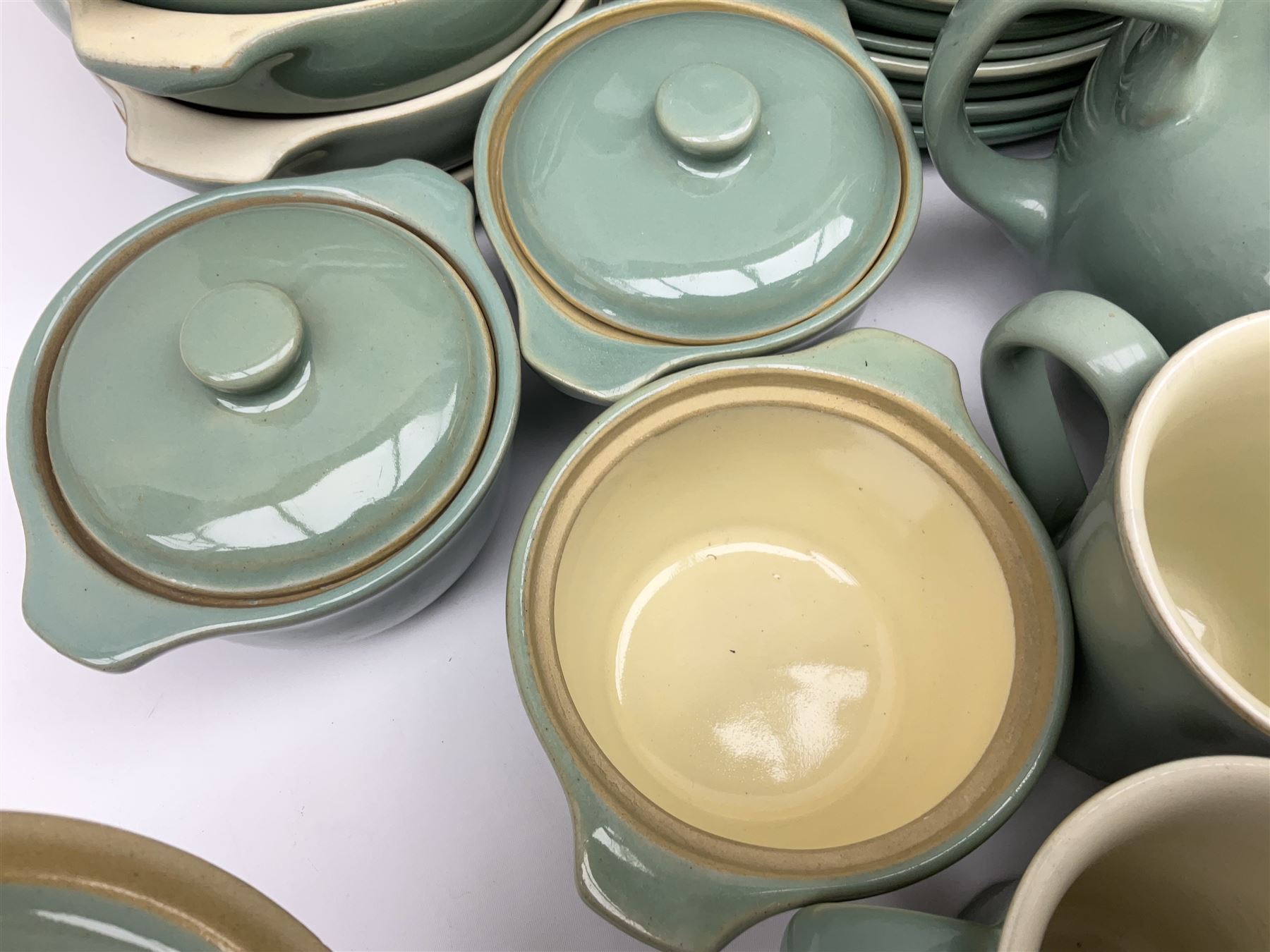 Denby Manor Green pattern part tea and dinner service, to include seven dinner plates, thirteen side plates, ten dessert plates, two oval dishes of various sizes, four cups and saucers, seven bowls with covers, two teapots etc (74)  