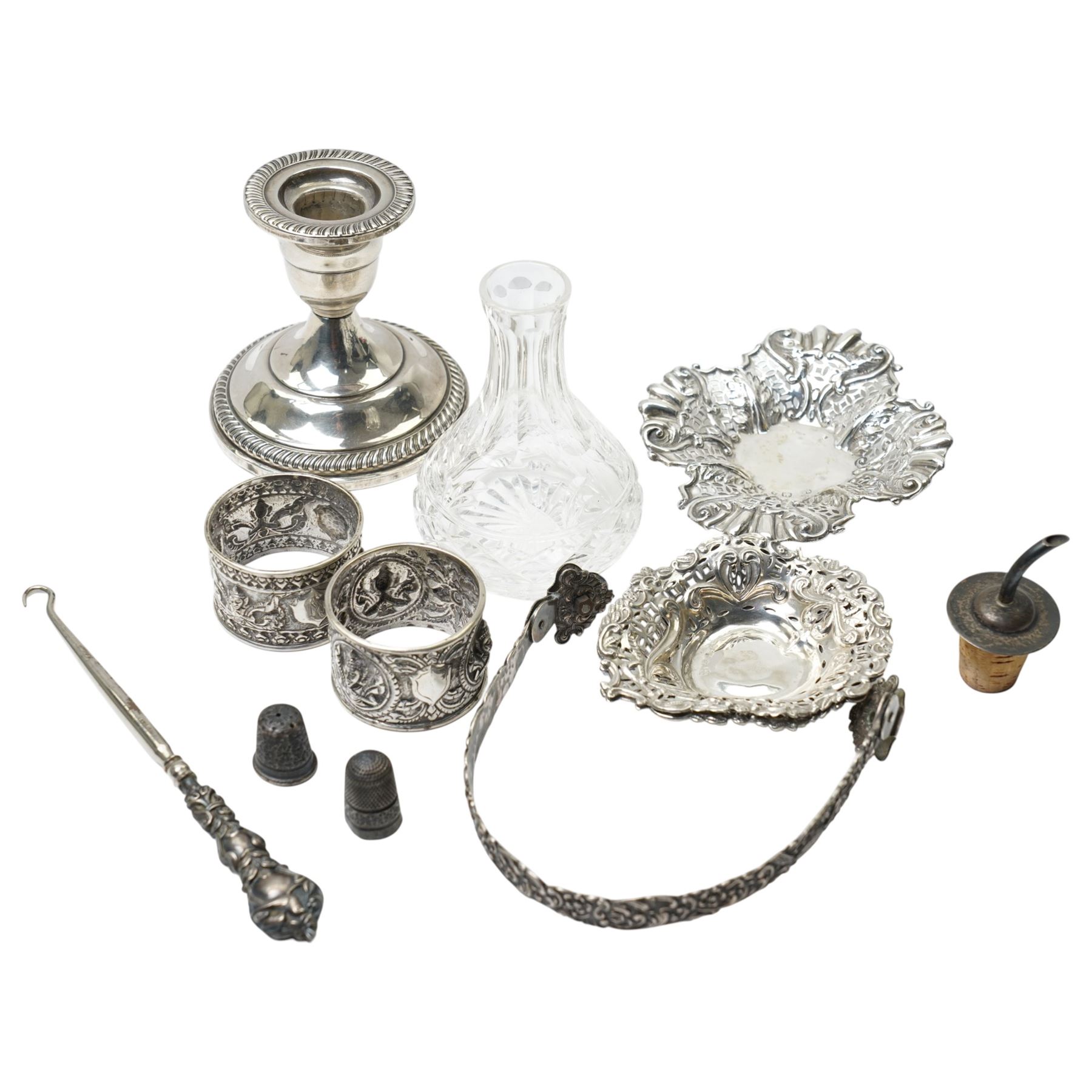 Two Indian white metal napkin rings, sterling silver candlestick, pair of silver heart shape sweetmeat dishes Chester 1895, single sweetmeat dish and other items