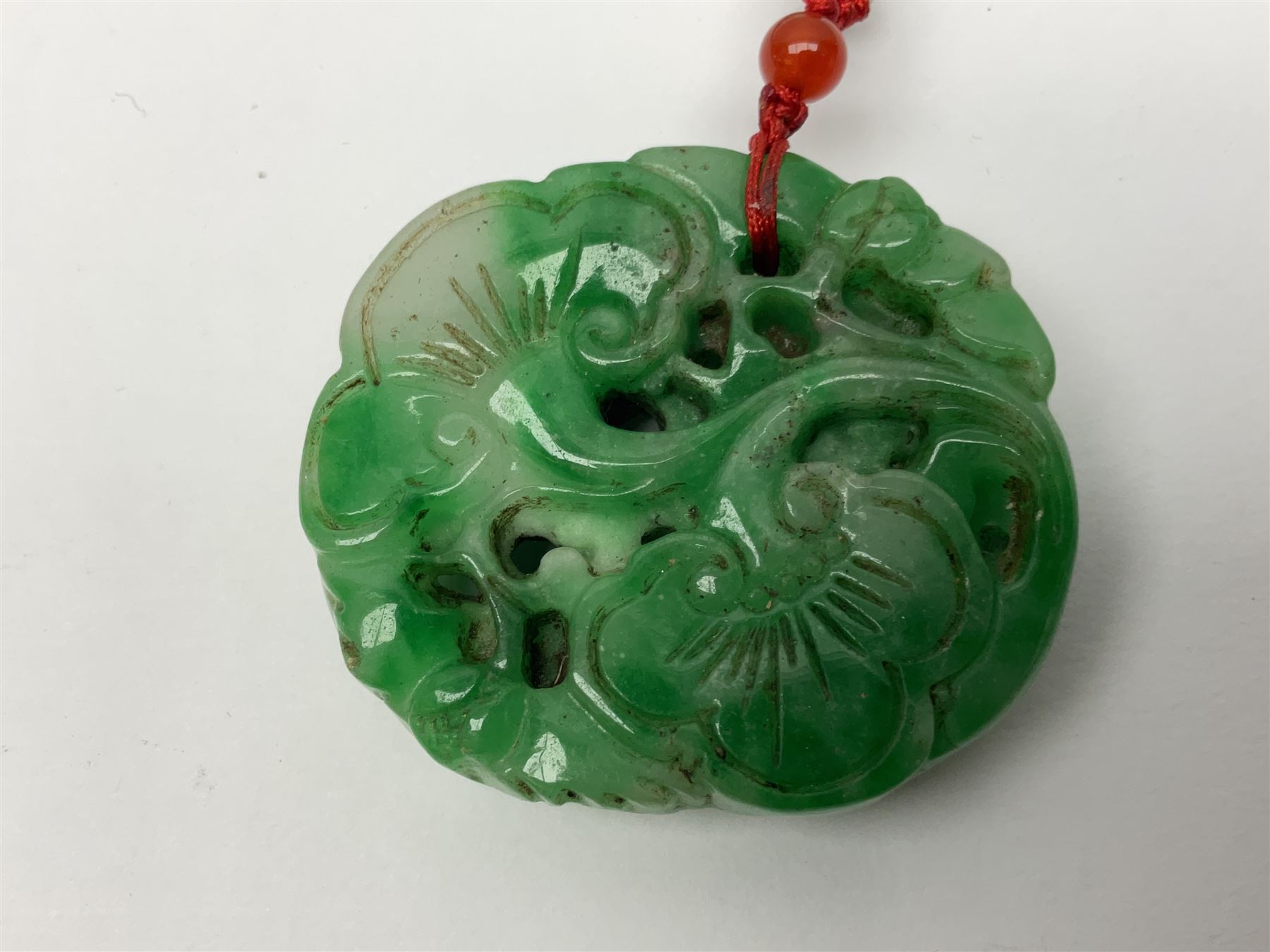 Chinese hardstone carving of a fish amongst coral, with platted rope handle, together with other hardstone and soft stone carvings  