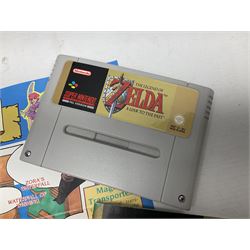 Two Super Nintendo Entertainment System (PAL) controllers, accessories and games. Super NES Game Commander with original box and instruction booklet, Super NES Nintendo Scope (1992) transmitter gun, receiver, Super NES Nintendo Scope 6 game with original instruction booklets. Further games to include ‘The Legend of Zelda a Link to the Past’, ‘Super Mario World’, ‘Super Mario Kart’, ‘The Lawnmower Man’, and ‘Exhaust Heat’, all with original instruction booklets. ‘PowerMonger’ and Disney’s ‘Aladdin’ game cartridges only 