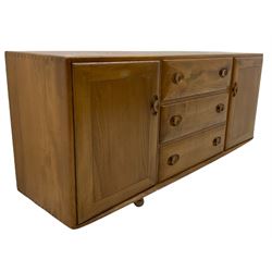 Ercol elm sideboard, three drawers and two cupboards, on castors