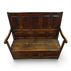 18th century oak high-back settle or hall bench, the panelled back and arm terminals over a hinged box seat, panelled front on short stile feet