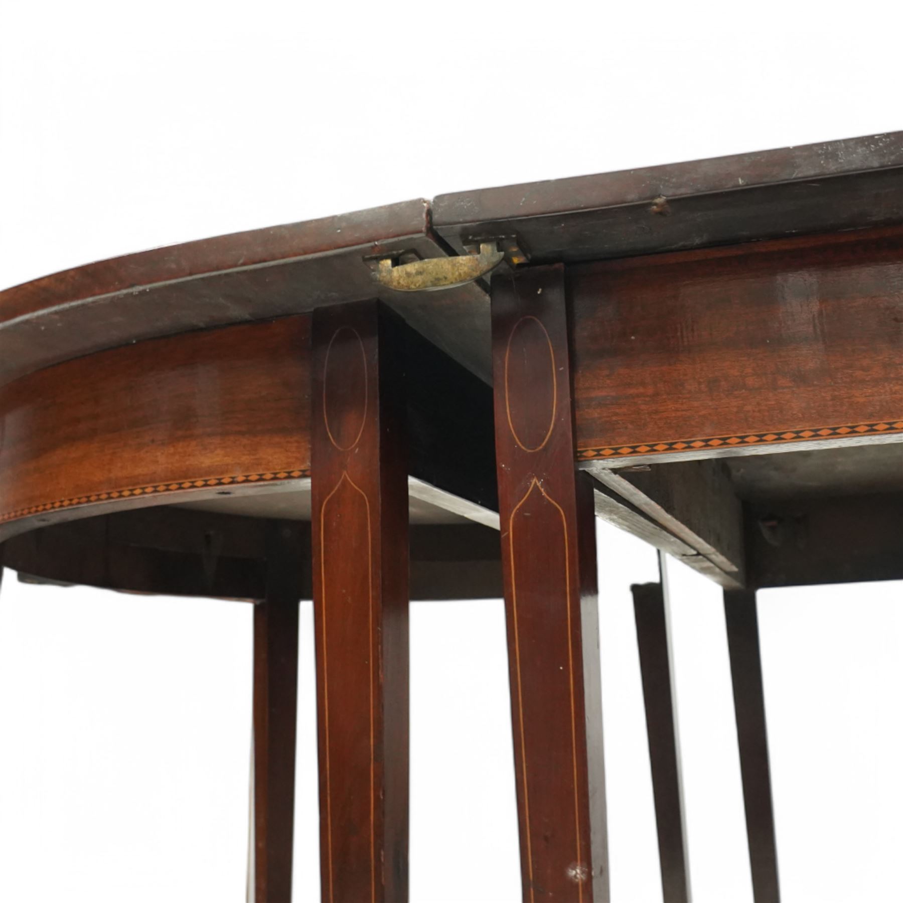 George III and later mahogany extending dining table, two D-ends, central drop-leaf table and loose leaf, satinwood banded tops, on square tapering supports with boxwood stringing
