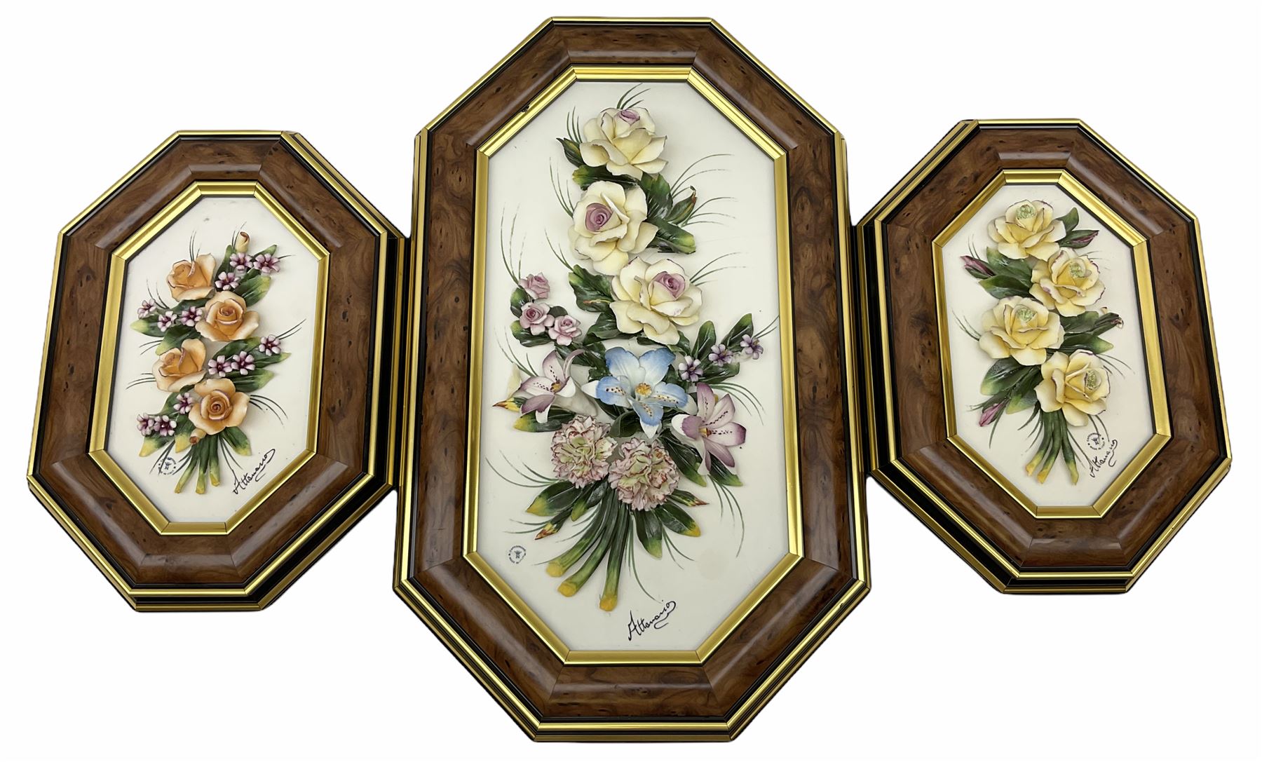 Set of three Capodimonte wall plaques, depicting floral decoration in octagonal frames with gilt edging, largest plaque H48, two small plaques H31cm.    
