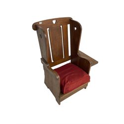 Arts and Crafts design oak reading wingback armchair, high back with pierced heart design, drop-leaf side table to one arm