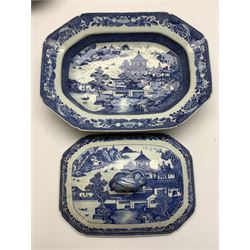 Late 18th/early 19th century Chinese export blue and white forty seven piece part dinner service, comprising twenty eight octagonal plates, seven octagonal bowls, four canted rectangular platters (including a pair of the same size), pair of small canted rectangular plates, canted serving dish, cover with vegetable knop finial, and two lobed sauce boats and shaped stands, each decorated with figures conversing before a temple, within a landscape set with typical motifs including waterside huts, boats, fence and bridge, within foliate and cell borders, plates D23cm, bowls D23.5cm, serving dish W36cm, largest serving platter W44.5cm 