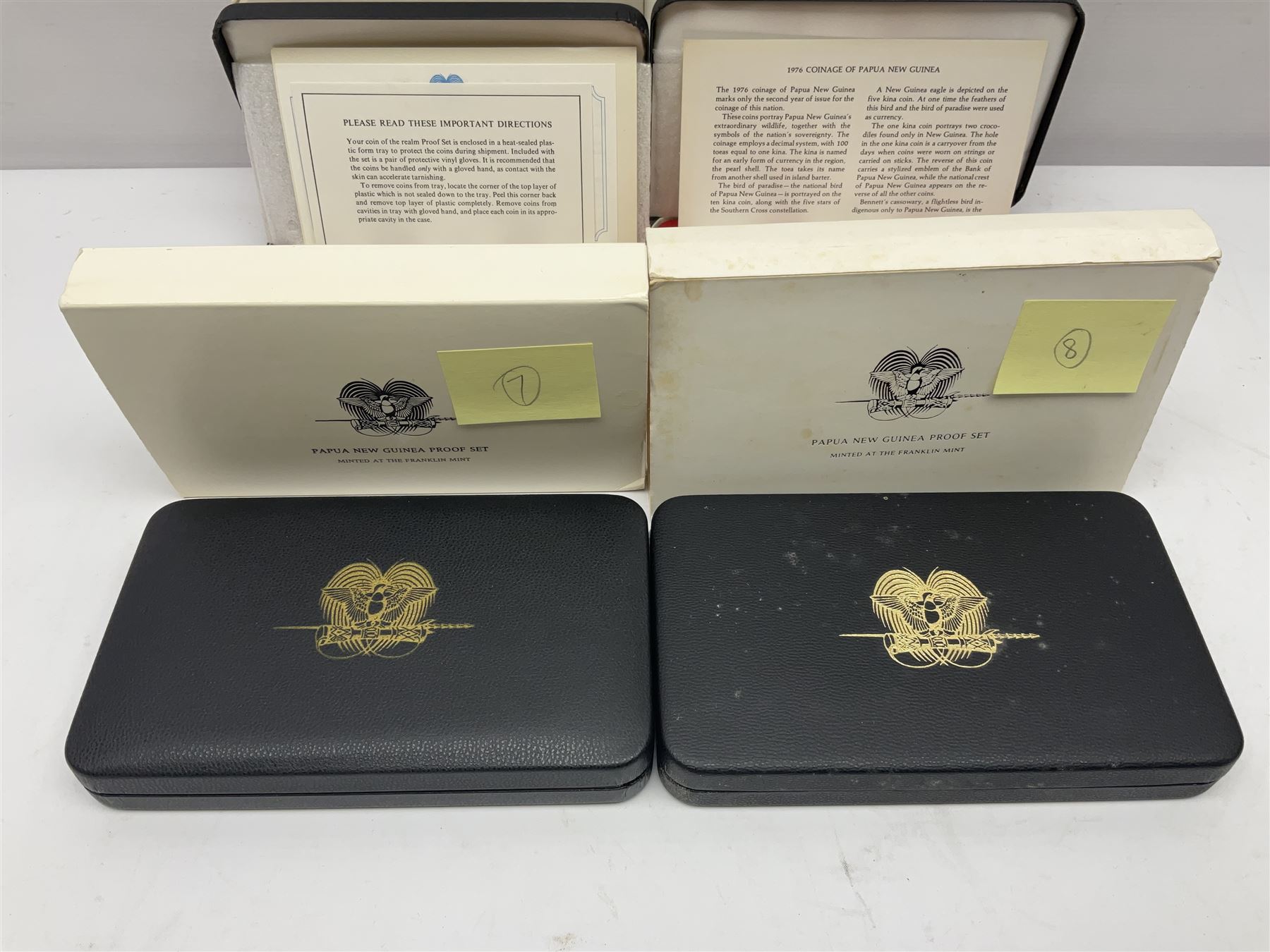 Four Papua New Guinea proof eight coin sets, from ten kina to one toea, comprising First Coinage of Papua New Guinea 1975 proof set, 1976, 1977, and 1979 proof sets, the 1977 and 1979 sets containing 925 silver ten kina and 500 silver five kina coins, all minted at the Franklin Mint, cased with certificates (4)