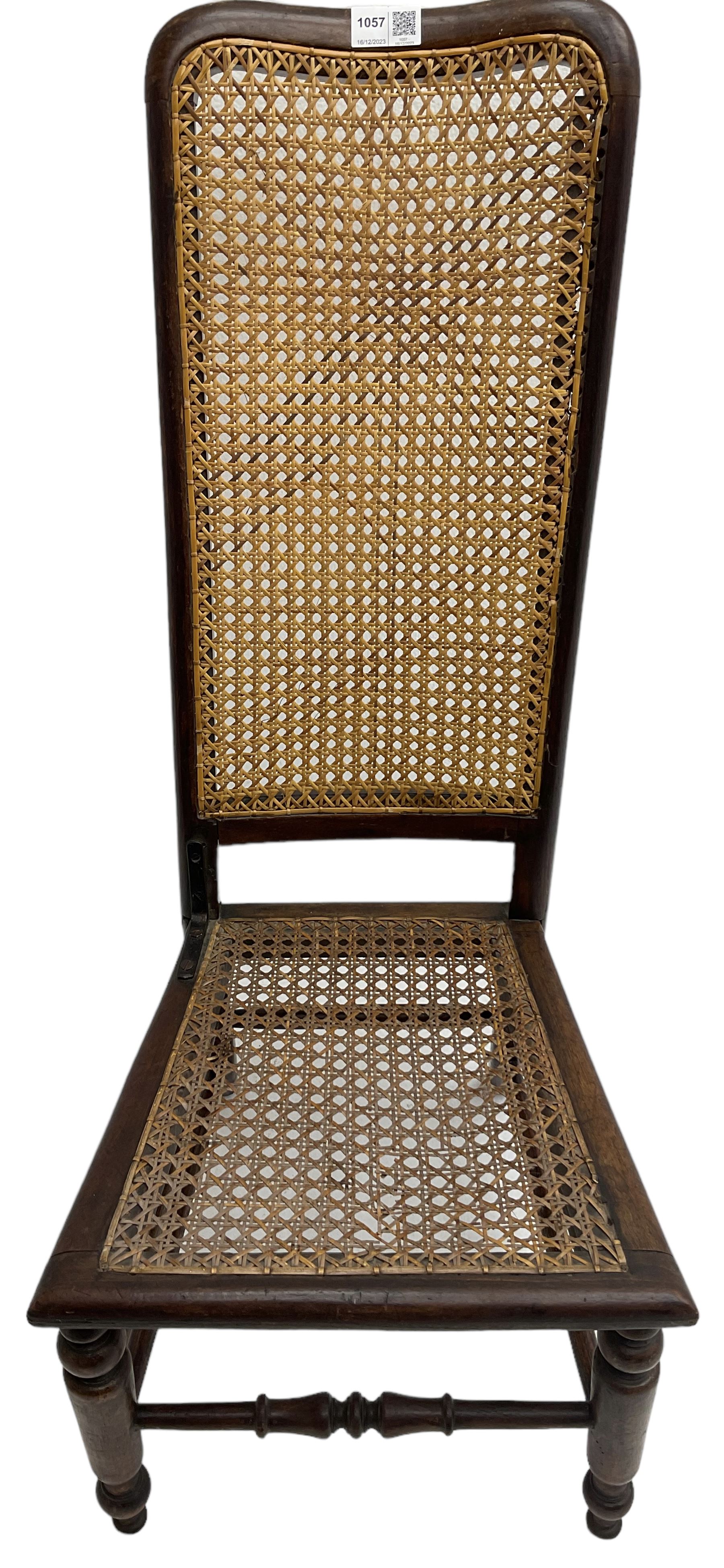 Early 19th century stained beech and mahogany child's correction chair, cane seat and back raised on turned supports united by stretchers