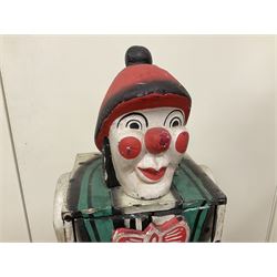 Folk art circus clown cabinet, the the two hinged doors with bow tie decoration opening to reveal fitted shelved interior, the body painted with polka dots and spades, H121cm