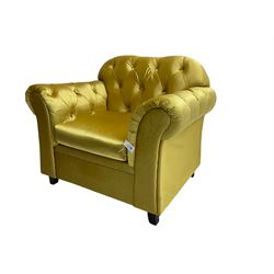 Chesterfield shaped armchair, upholstered in buttoned gold fabric, with scatter cushions