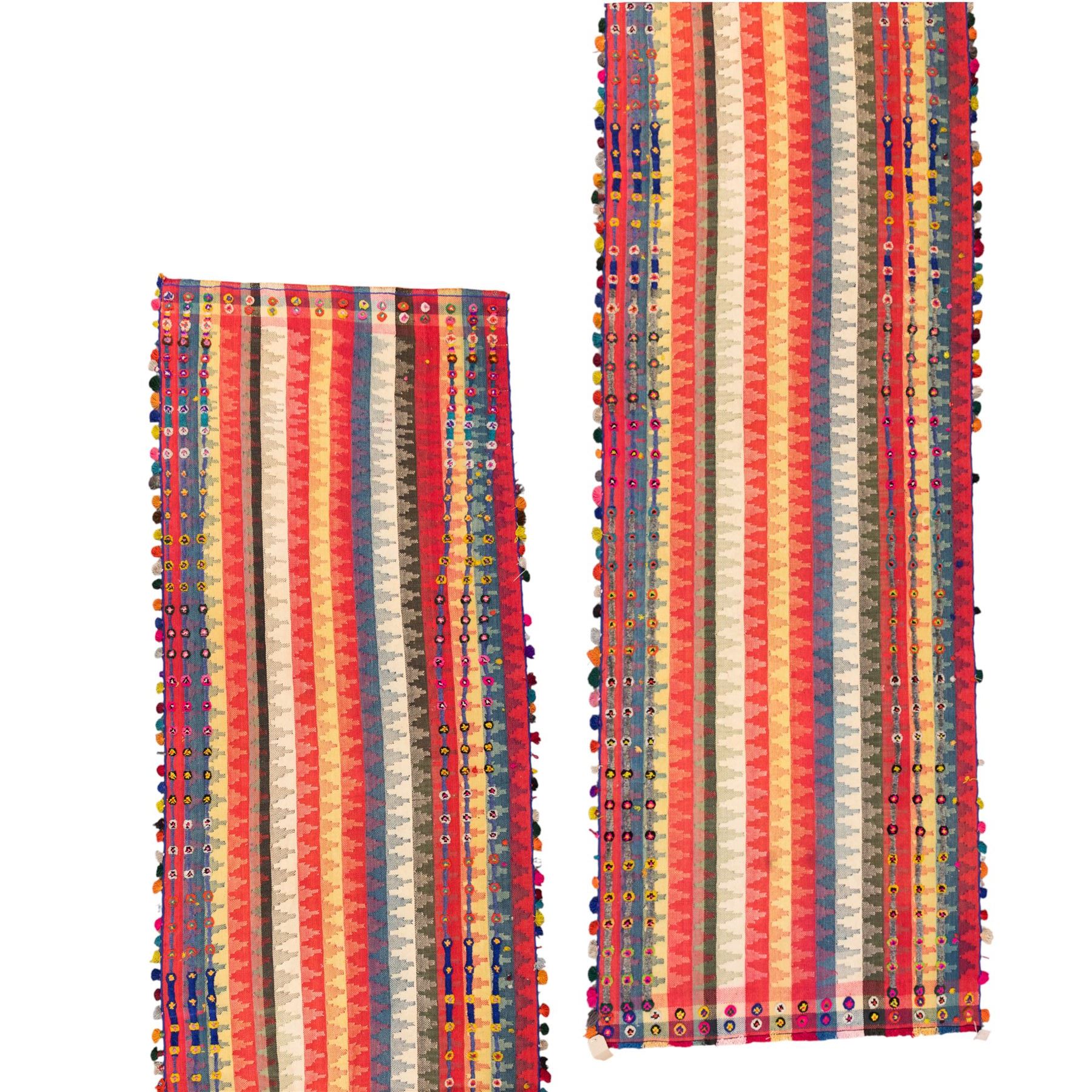 South West Persian Jajim kilim flatweave runner, woven in warp-faced flatweave and composed of narrow bands, striped field in various shades of rose, coral, ivory, indigo, turquoise, and olive, embellished along the sides with applied knotted wool rosettes and tassels, some missing (due to large size, the runner is illustrated in two sections)