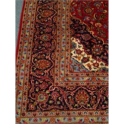  Kashan red ground rug, central medallion, floral field, repeating border, 409cm x 300cm  