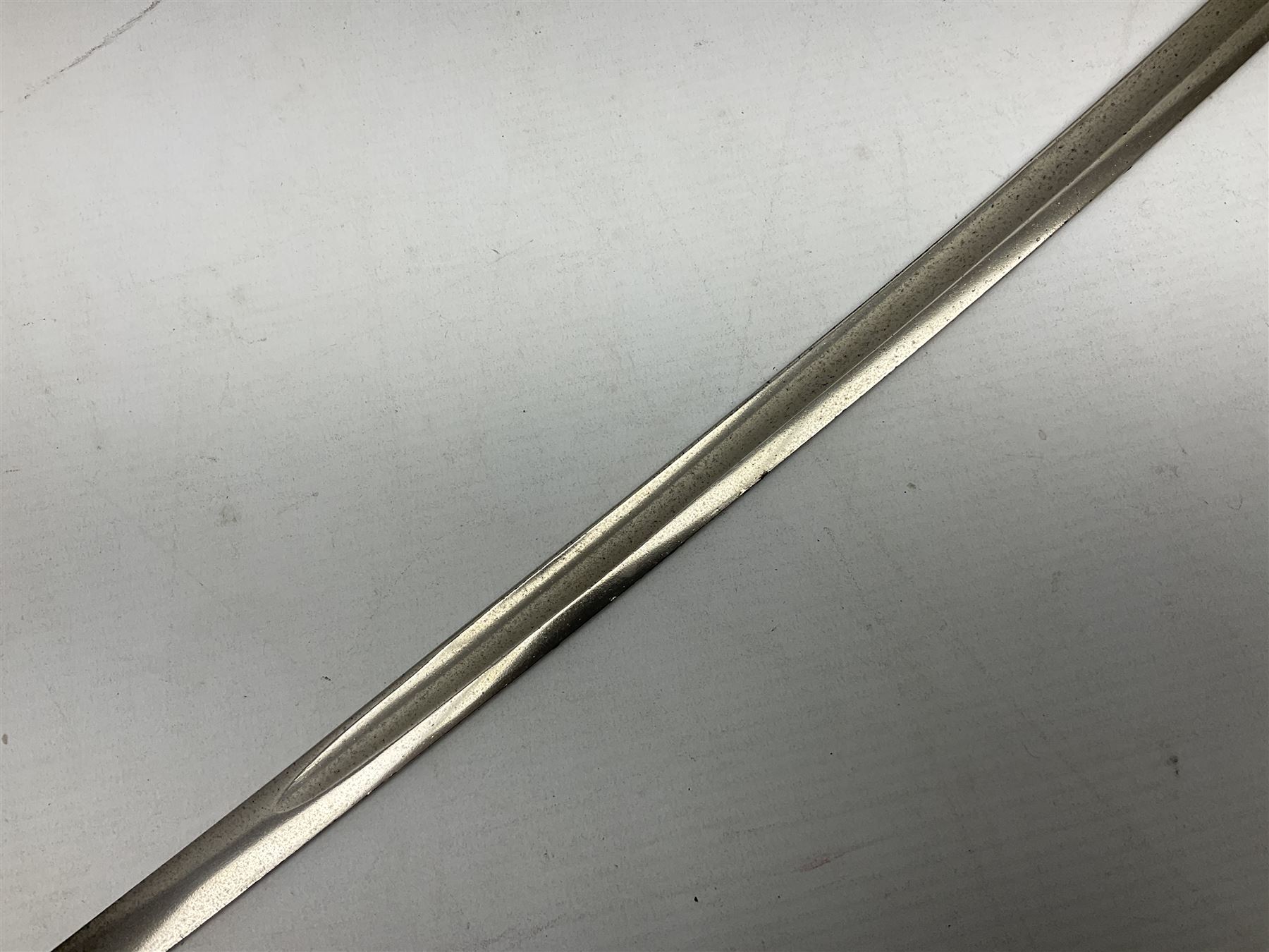 1900-1918 German Imperial NCO sabre with WW2 modifications of Wehrmacht insignia to the langet, 79cm slightly curving fullered blade and brass hilt, the knucklebow chased with oak leaves and acorns L90.5cm overall
This item has been registered for sale under Section 10 of the APHA Ivory Act 