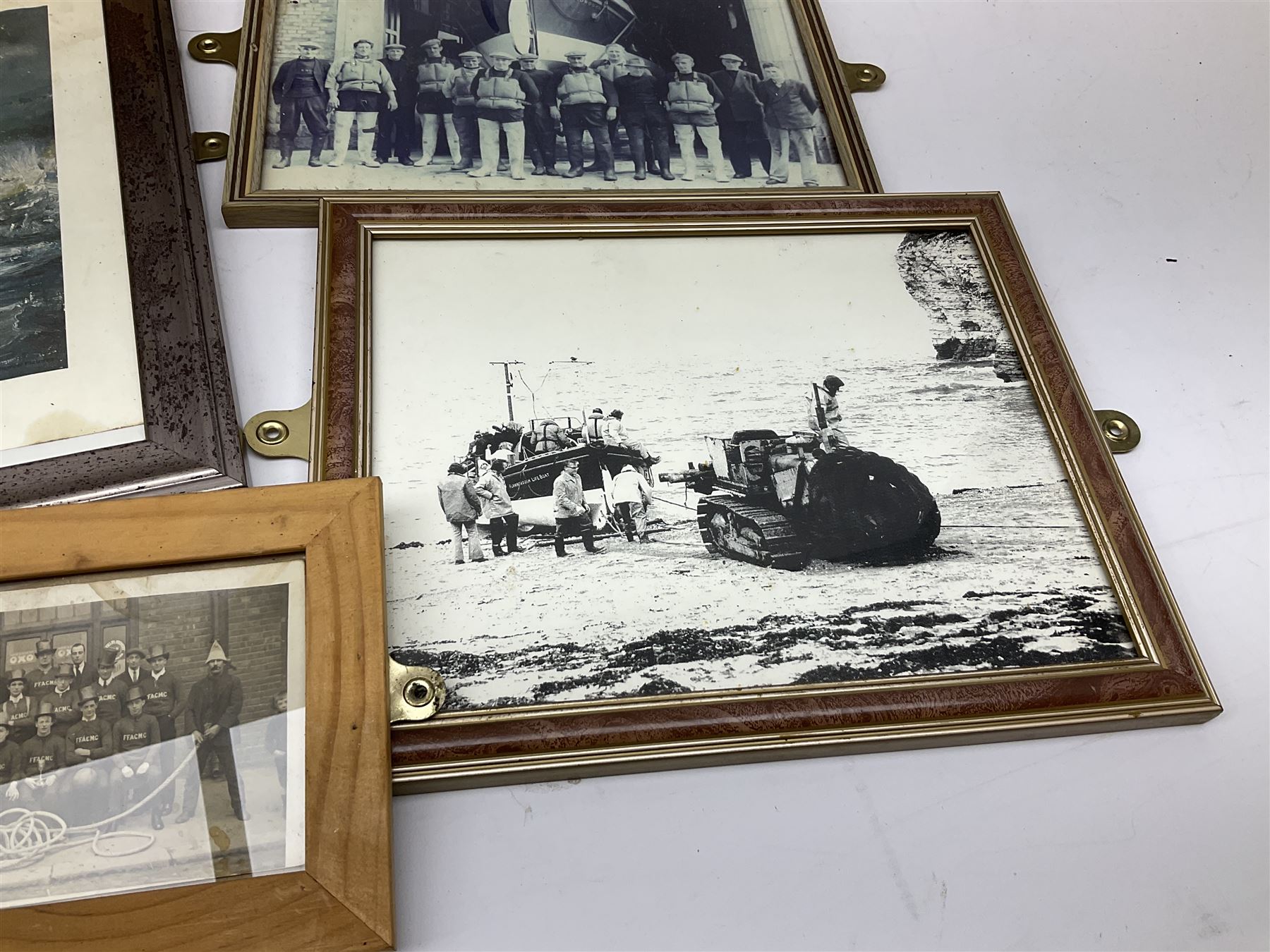 RNLI collection box in the form of a boat makers half block model, painted in the colours of a lifeboat with flag and ship motifs, H25cm, L73cm together with framed photos, postcards and prints of lifeboats and crew, including Scarborough lifeboat station