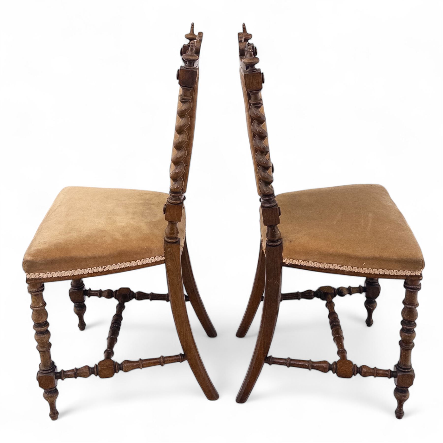 Pair of 19th century oak hall chairs, shield form backs with carved scroll cresting and finial uprights, upholstered in tan velvet, on turned and block supports joined by stretcher rails