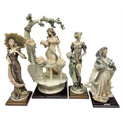 Four Giuseppe Armani figures, comprising The Flower-girl, Lady with Umbrella, Forget Me Not and Cedraschi  