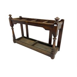 Edwardian oak hallway stick and umbrella stand, four divisions on turned supports, with metal tray liners and various sticks