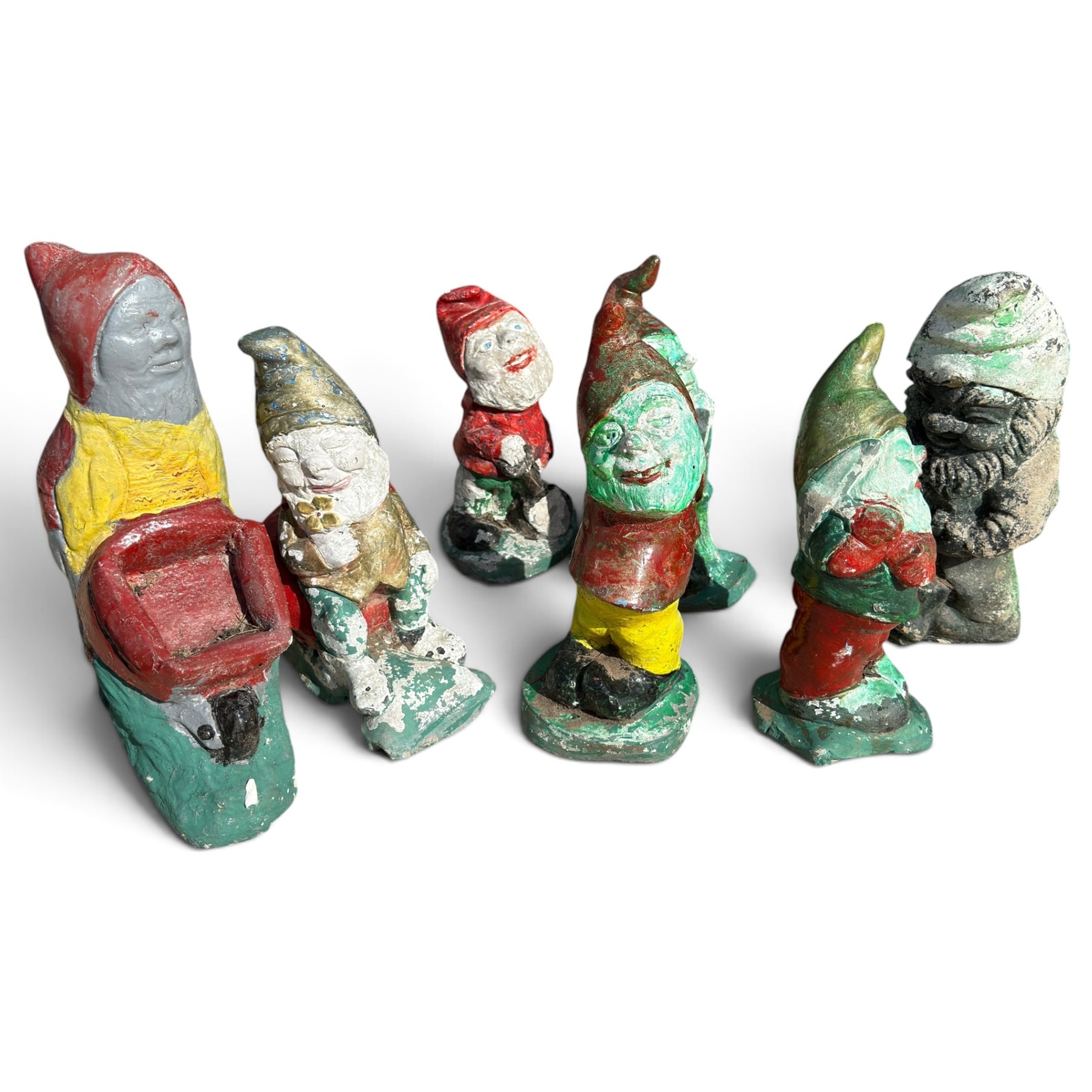 Bronzed composition figure of a seated French bulldog, together with a collection of vintage painted cast stone garden gnomes
