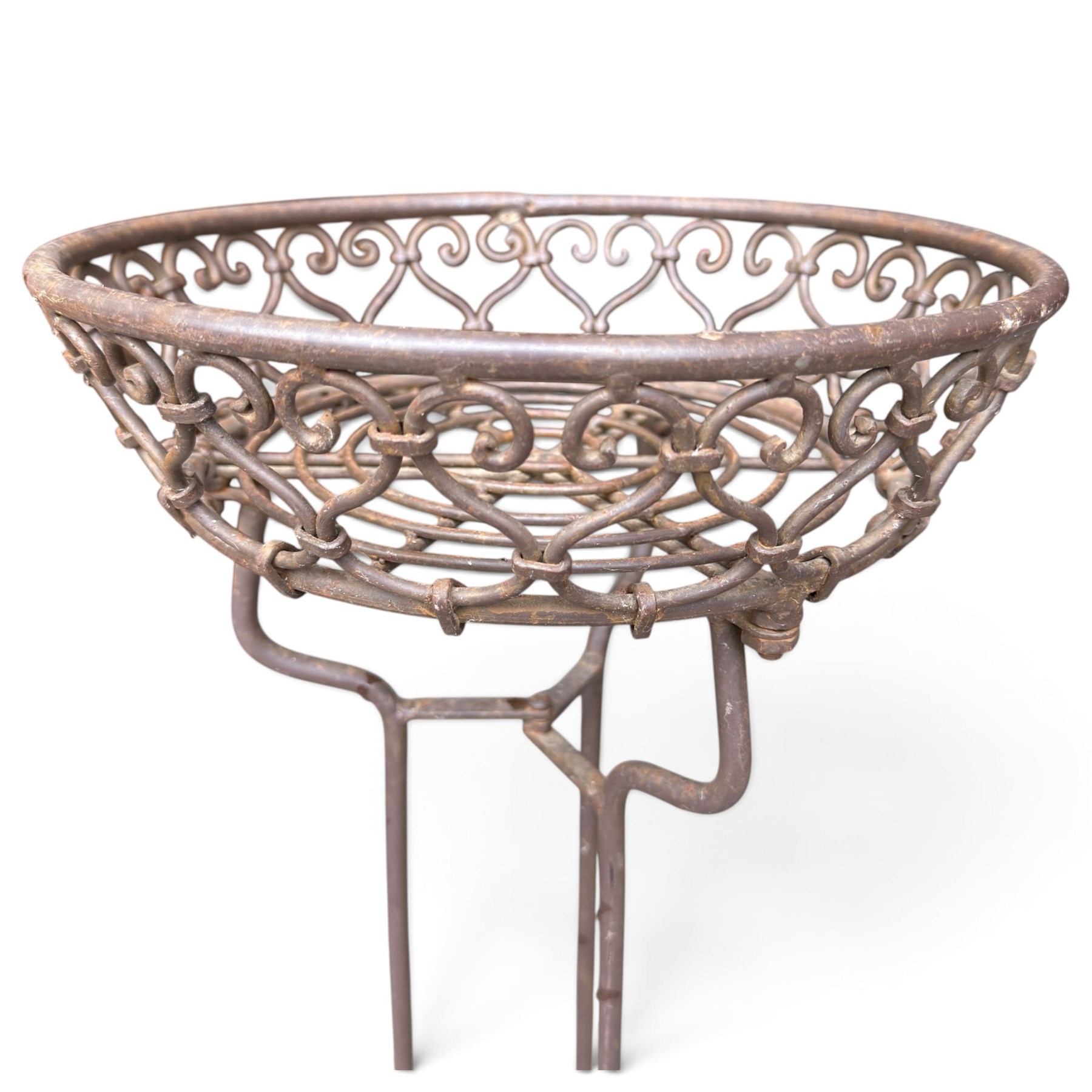 Three wrought iron garden basket planters, comprising a circular pierced and scrolling basket on tall tripod stand with scrolling supports (W31cm H76cm), and a pair of matching hanging baskets (W37cm H30cm)