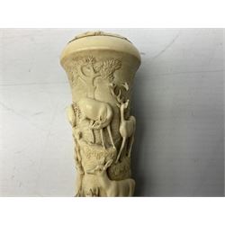 19th century carved ivory walking cane or parasol handle, of tapering form with screw thread interior, the sides carved in relief with deer upon rocky ledges, the top carved with oak leaves, H10.5cm