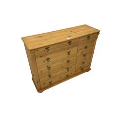 Pine chest, fitted with five short and five long drawers flanked by fluted uprights, on compressed bun feet