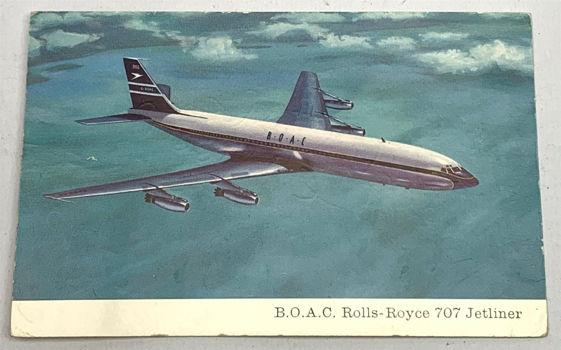  RTV   The Beatles - four signatures on the reverse of a B.O.A.C. Rolls-Royce 707 Jetliner postcard comprising Paul McCartney, Jimmie Nicol, John Lennon and George Harrison.  In June 1964 The Beatles were about to embark on a tour which would take in Denmark, The Netherlands, Australia and New Zealand before returning to the UK but a few days before the start of the tour Ringo was rushed to hospital with severe tonsillitis and needed an immediate operation. Cancellation of the tour at this late stage would have caused a great deal of problems so Brian Epstein looked for, found and auditioned another drummer, Jimmie Nicol. Although George Harrison was not happy with the arrangement the tour proceeded with Nicol as their drummer. As soon as Ringo recovered he flew to Melbourne and joined The Beatles who then went on to finish the tour. Nicol only played eight shows and was a Beatle for just thirteen days as he was flown home the very next day after Ringo's arrival in Melbourne.  Provenance: the signatures were given to the BOAC pilot who flew the Beatles on the tour. He then passed them on to his friend the Mayor of Chipping Norton, where he lived, and the vendor is the widow of the Mayor.