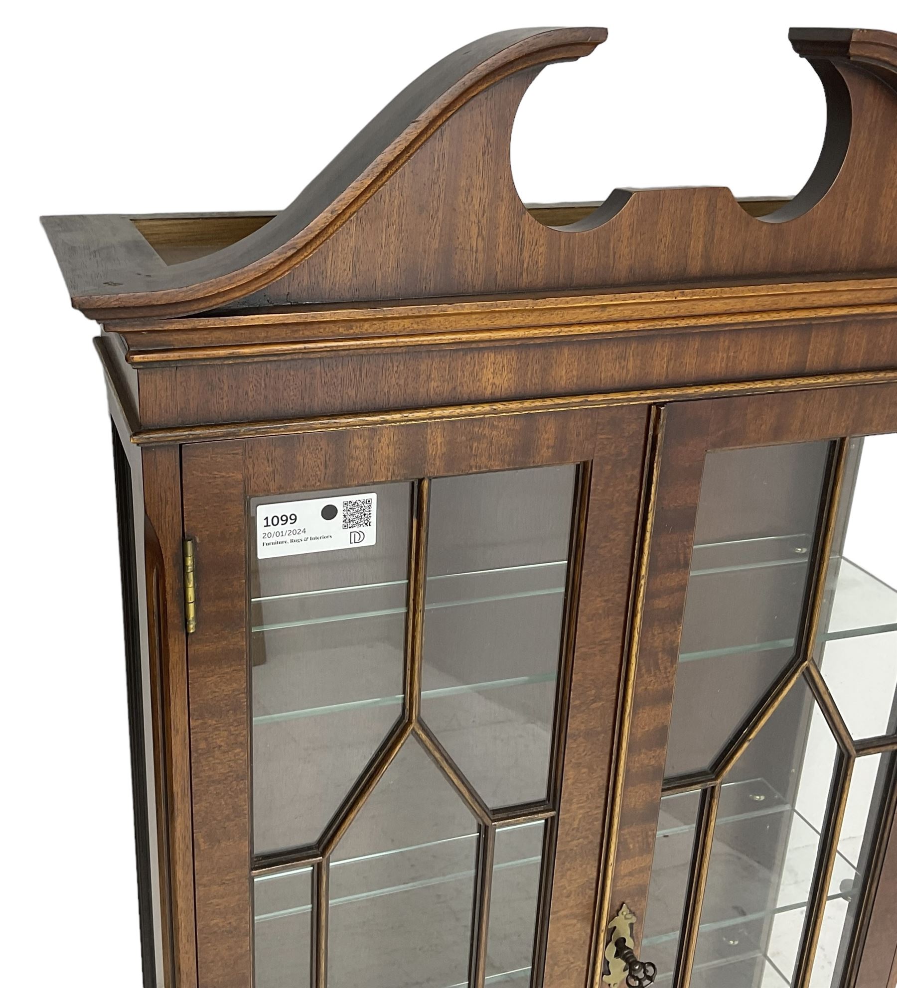 Georgian design mahogany wall hanging display cabinet, broken moulded swan neck pediment over two astragal glazed doors, the interior fitted with three glass shelves