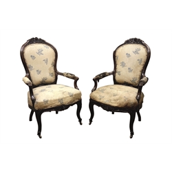  Pair 19th century French Rococo Paris quality rosewood upholstered open armchairs, moulded frames with floral carved cresting rail, scroll carved arm supports, serpentine floral carved apron and cabriole legs with beaded brass cups and wooden castors, sprung seat, W62cm, H104cm  