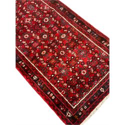 North West Persian Malayer runner, red ground field decorated with Herati motifs, guarded border decorated with trailing flowerhead band 