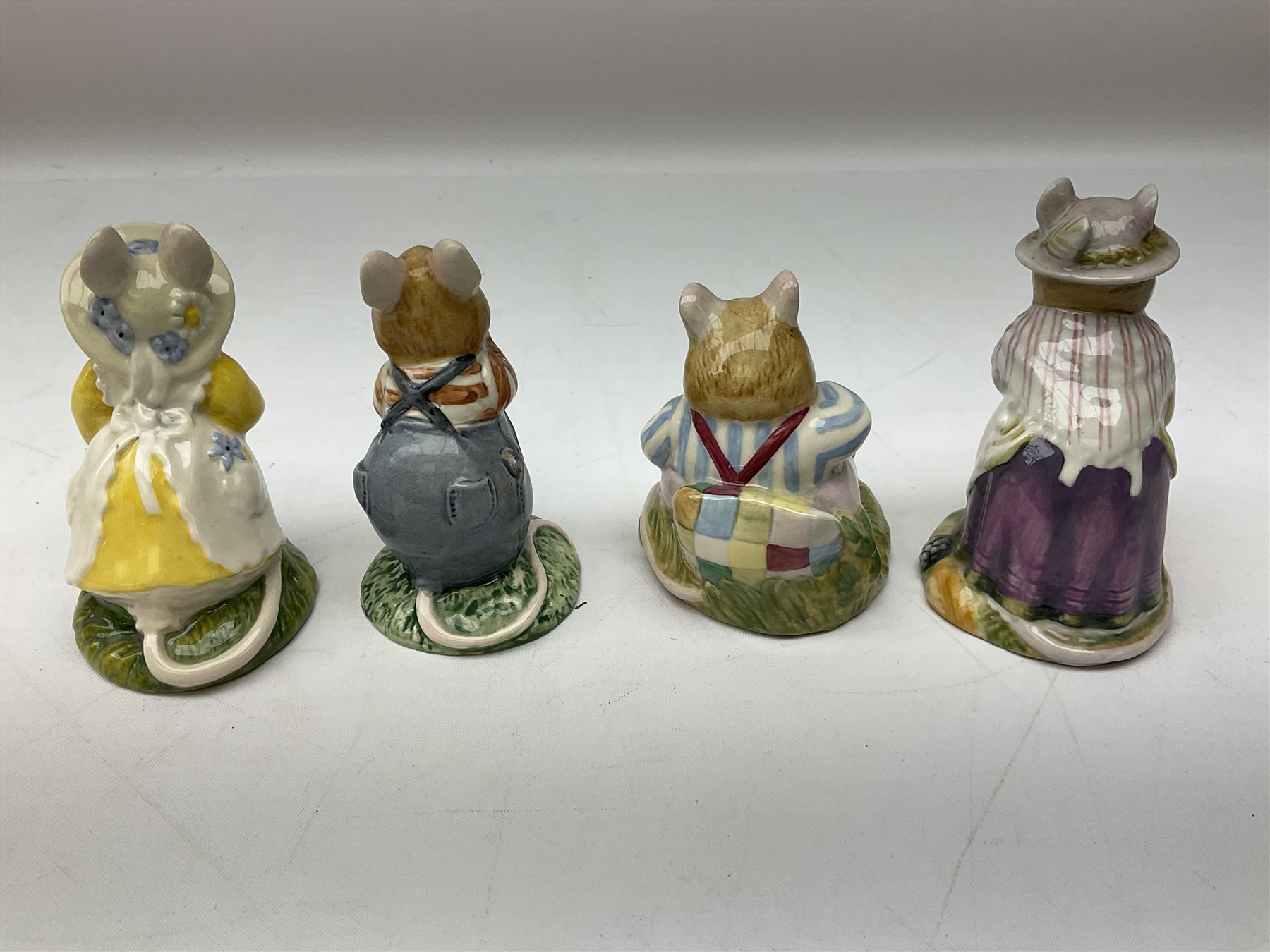 Fifteen Royal Doulton Brambly Hedge figures, comprising Wilfred Toadflax, Dusty Dogwood, Mrs Toadflax, Mr Apple, Primrose Woodmouse, Lord Woodmouse, Poppy Everbright, two Lady Woodmouse, two Old Mrs Everbright, Mr Toadflax, Mrs Apple, Santa Bunnykins and Bunnykins, together with three Royal Albert Wind in the Willows figures comprising Ratty, Badger and Mole, all with printed marks beneath (18)