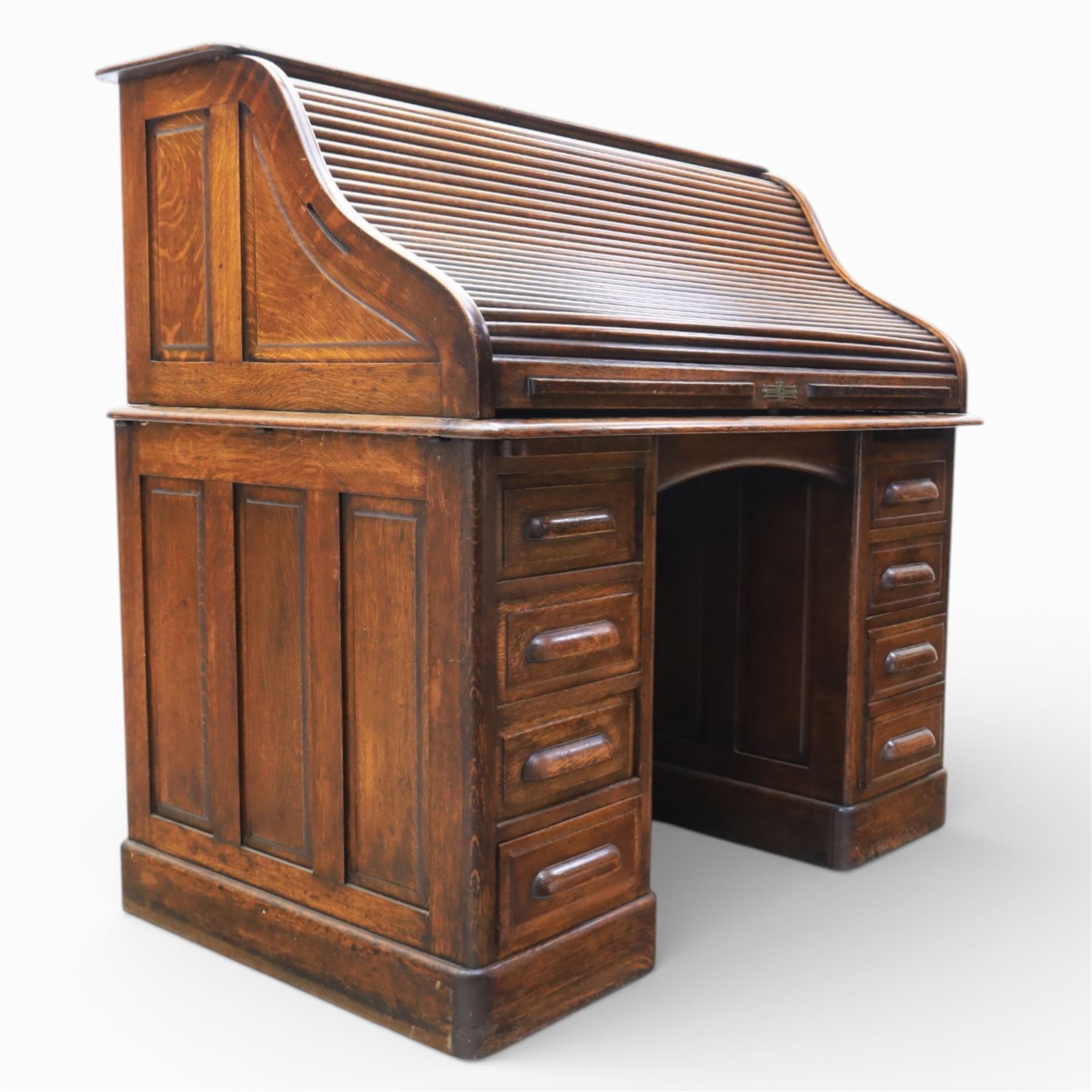 Globe Wernicke - Oak roll top desk, tambour roll top enclosing a fitted interior, raised on two pedestal bases with fitted drawers, raised on a plinth base 