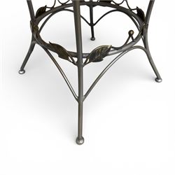 Wrought iron garden dining table with leaf decoration, and set of four matching chairs