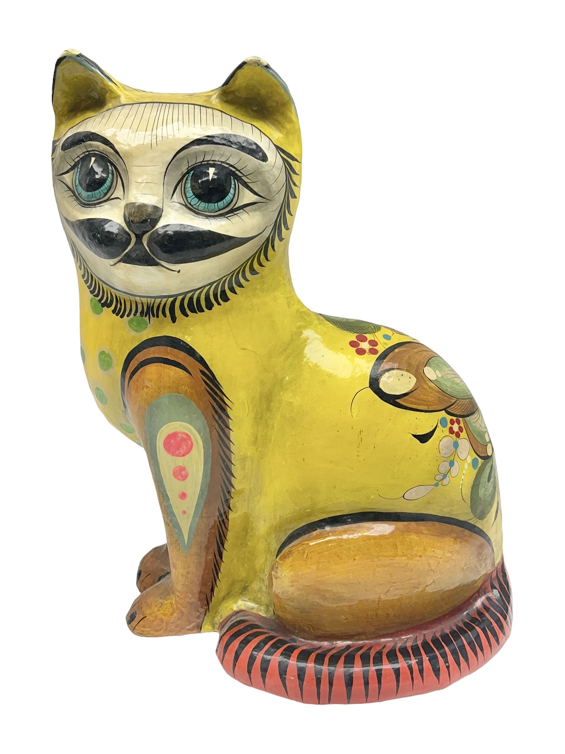 Papier mache model of a sitting cat, with painted floral and butterfly decoration, signed Serimel to base